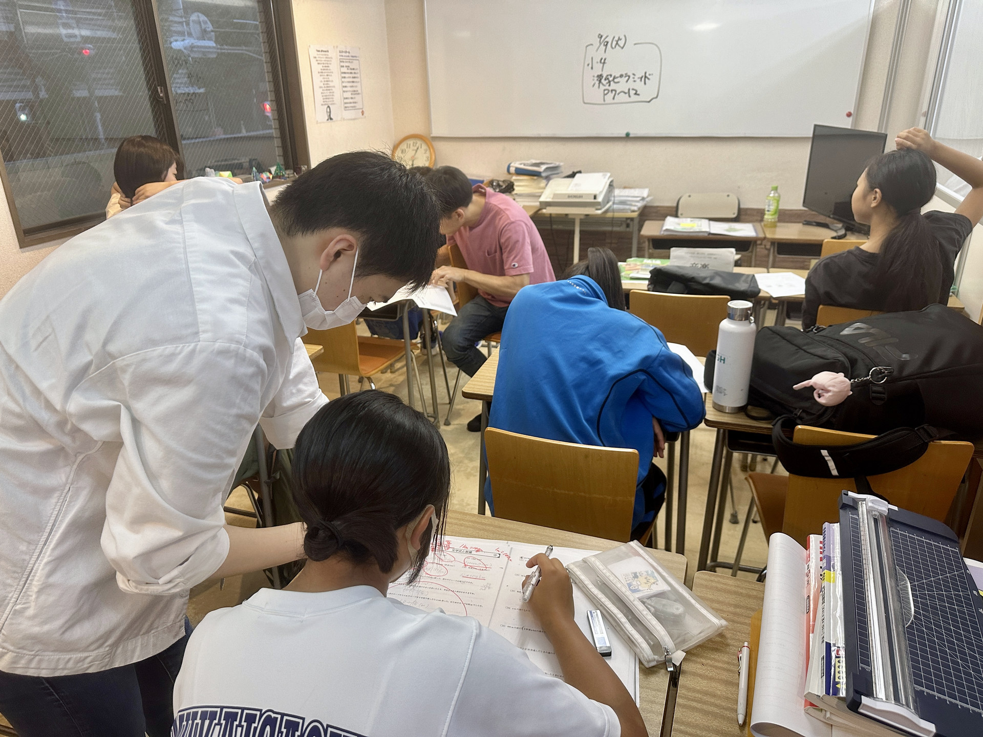 先生が生徒の演習を近くで確認する授業